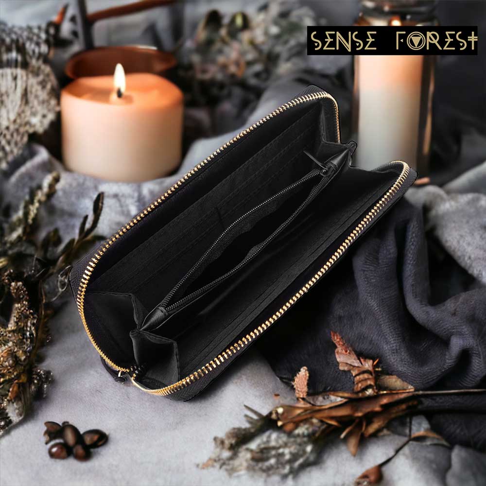 Black leather zip-around wallet with multiple compartments from Sense Forest, styled with autumn decor.
