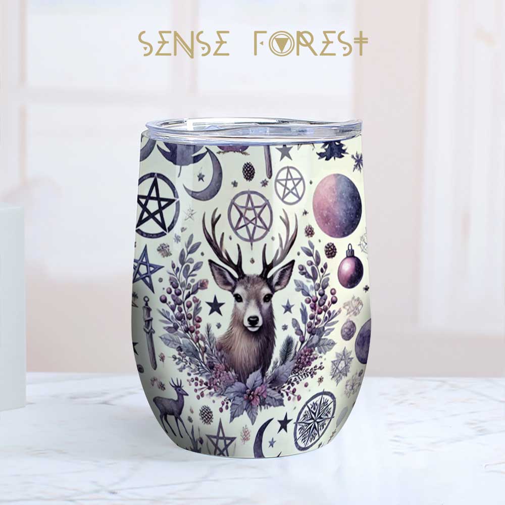 a pagan deer moon pentagram printed 12 oz wine tumbler on a kitchen counter top