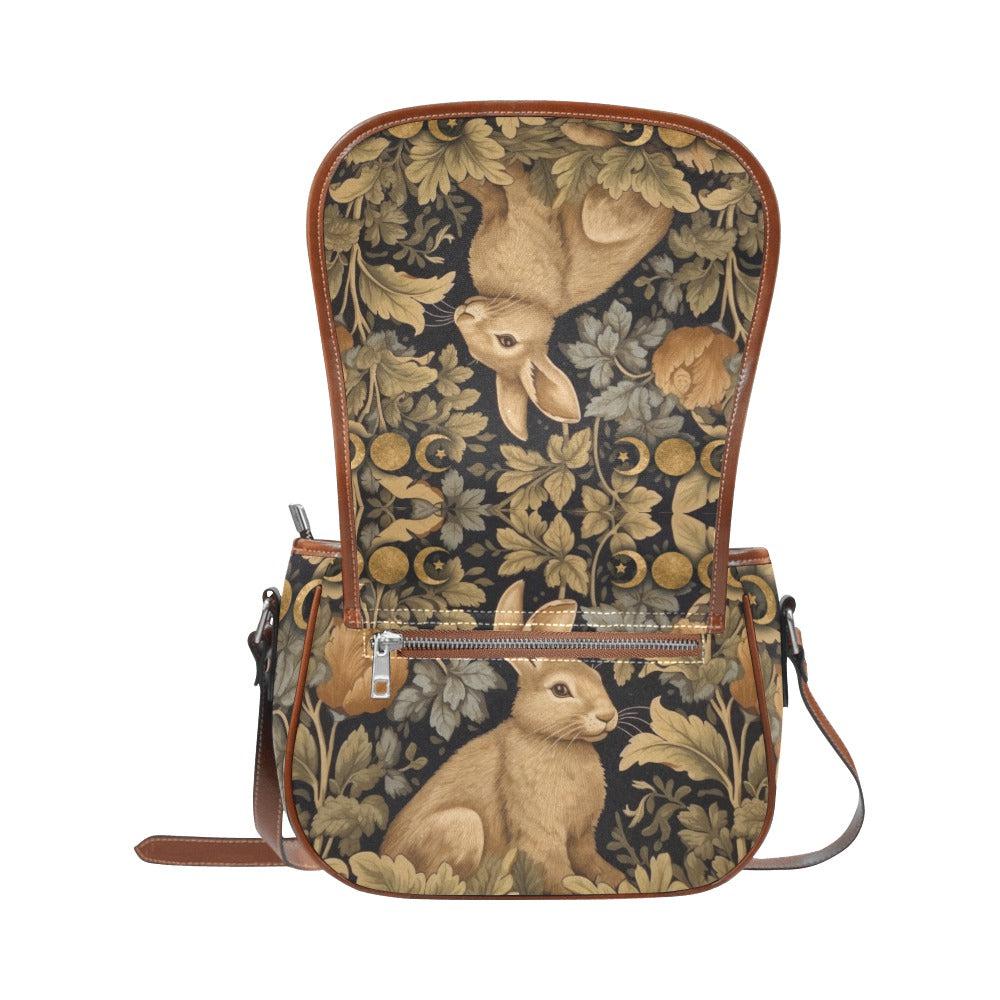 Retro botanical rabbit canvas saddle bag by Sense Forest with brown leather trim and adjustable strap.