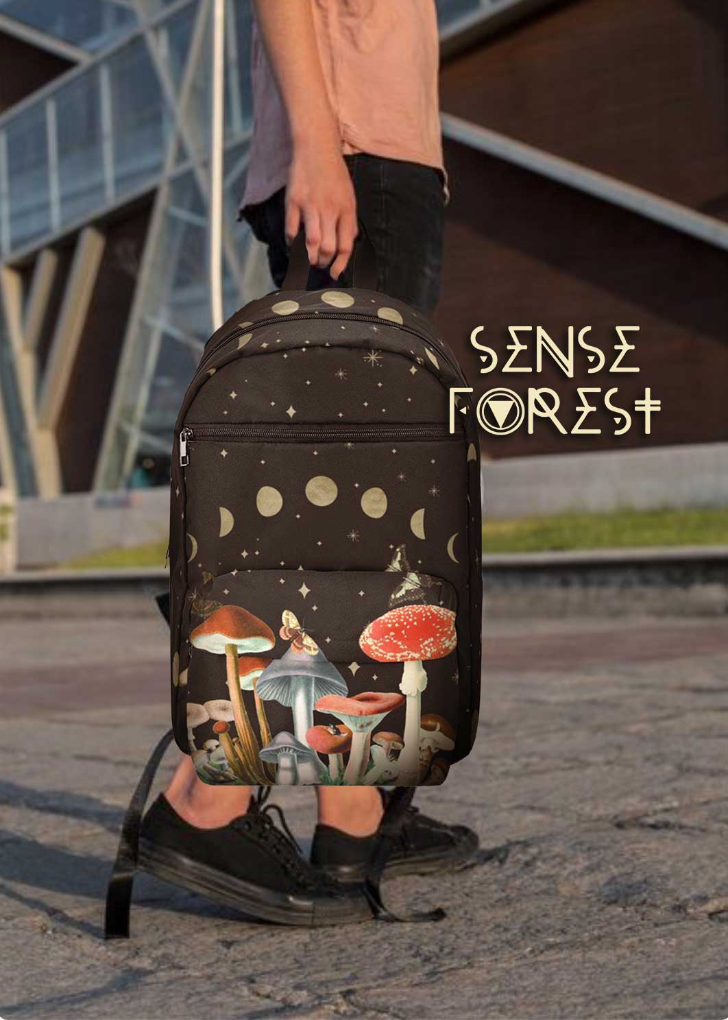 Black backpack with moon phase design and colorful red and white magic mushrooms, Sense Forest logo visible.