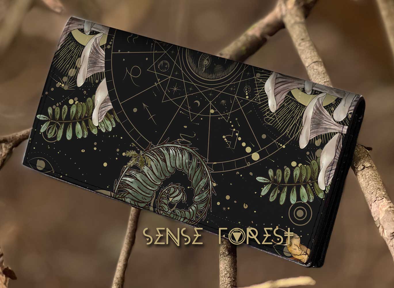 a forest witchy cottagecore bi-fold wallet on a tree branch in the forest