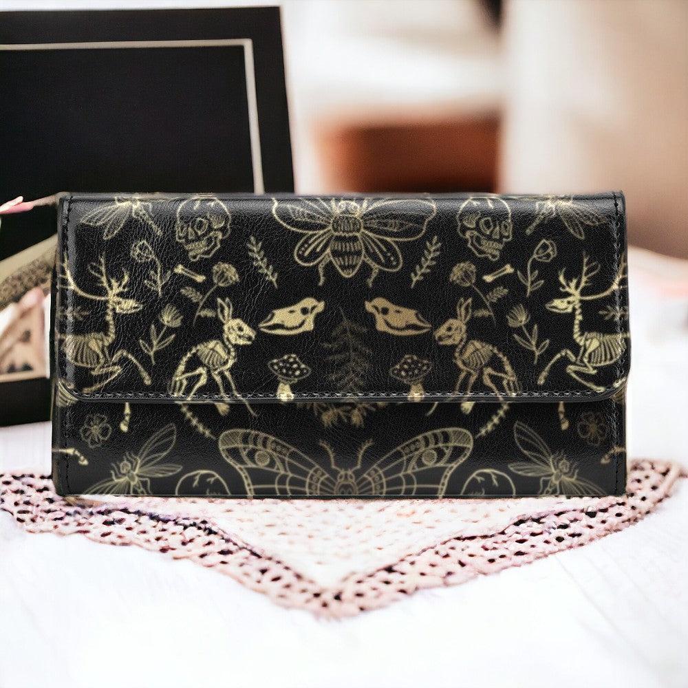 an elegant woman hand is holding a cottagecore rose witchy long clutch wallet