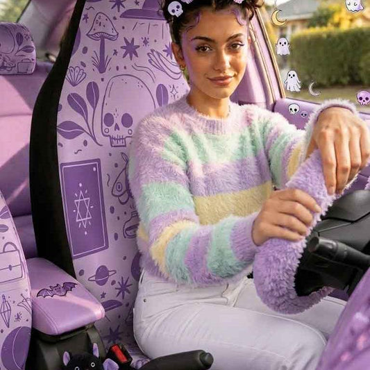 Person sitting in a car with a purple interior and cartoon character decorations.